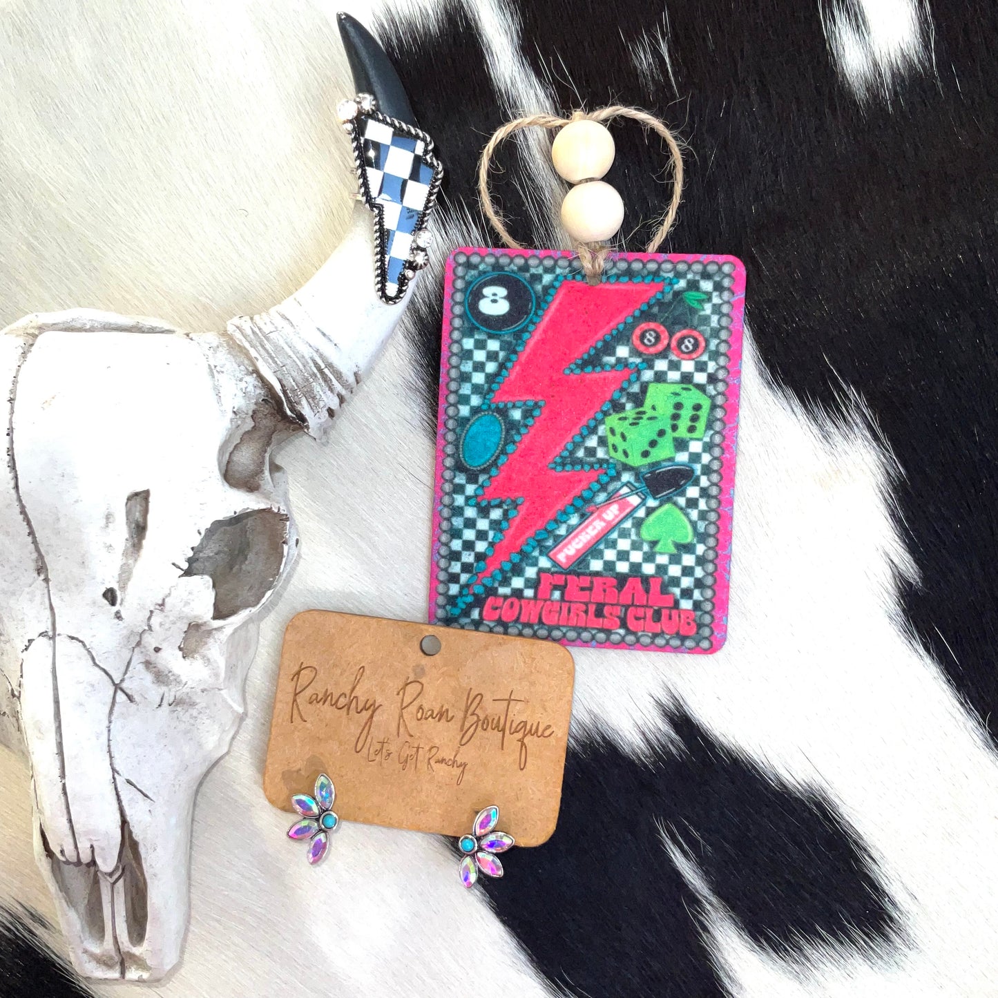 Rectangular freshie with Western-themed graphics, including a lightning bolt and dice, displayed alongside Western decor, capturing a vibrant, edgy style.