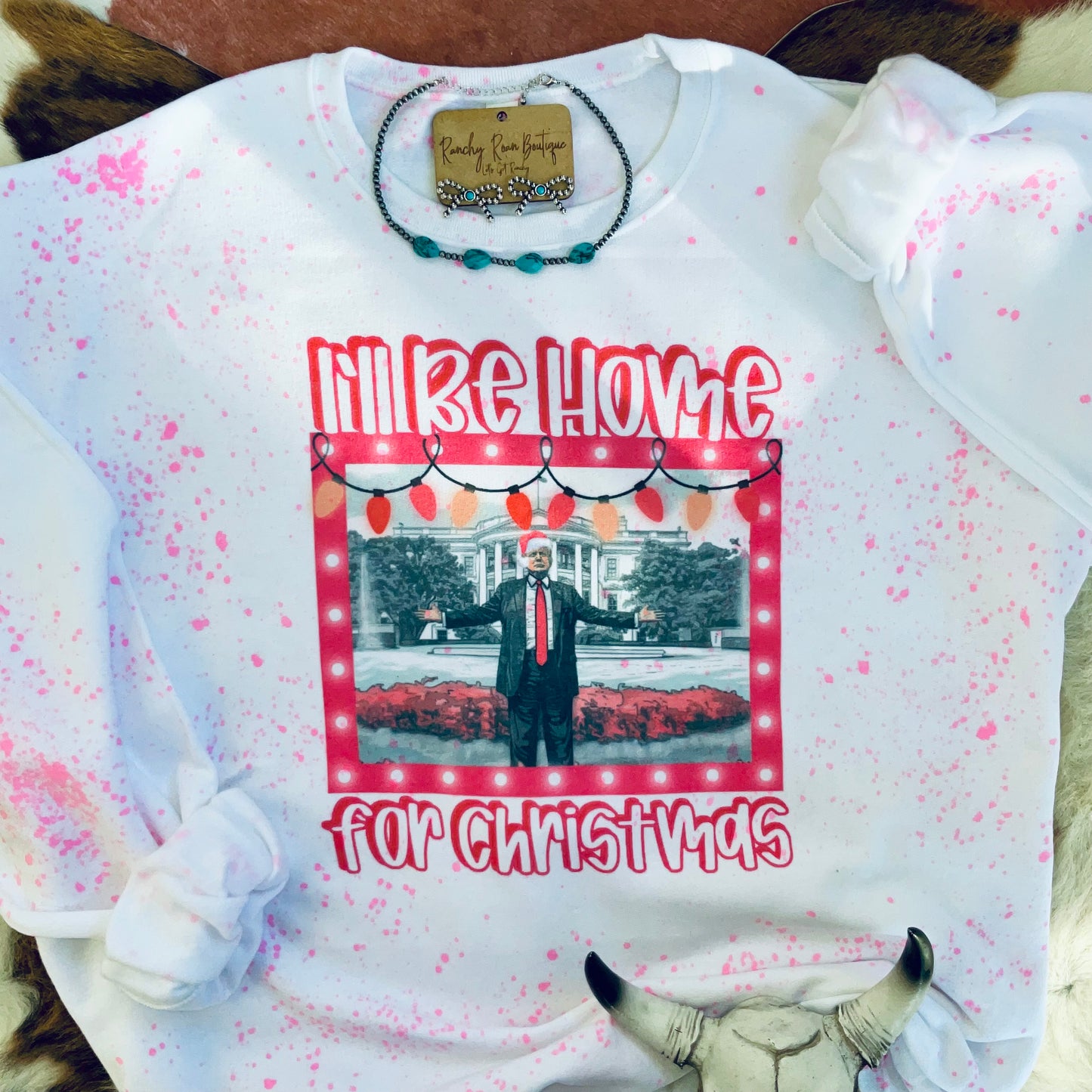 Full view of the splatter design sweatshirt with holiday graphics, perfect for boutique holiday collections.