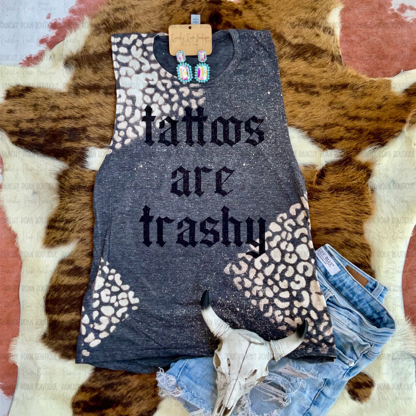 Tattoos Are Trashy Bleached Leopard Muscle Tank featuring bold gothic Western lettering with a hand-bleached leopard print pattern.