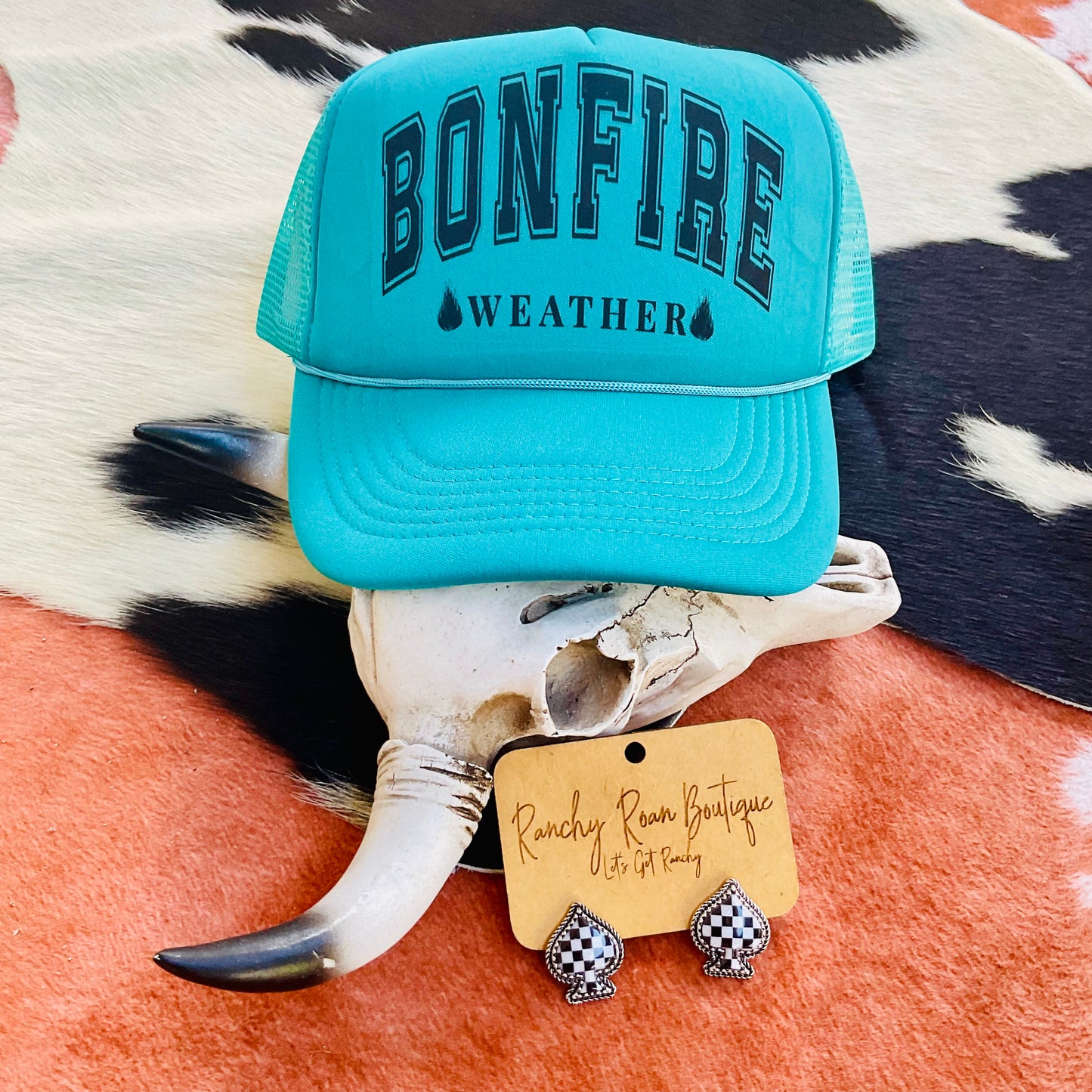 Foam front trucker hat with the bold text “Bonfire Weather” and adjustable snapback closure, featuring breathable mesh and a classic Western style.