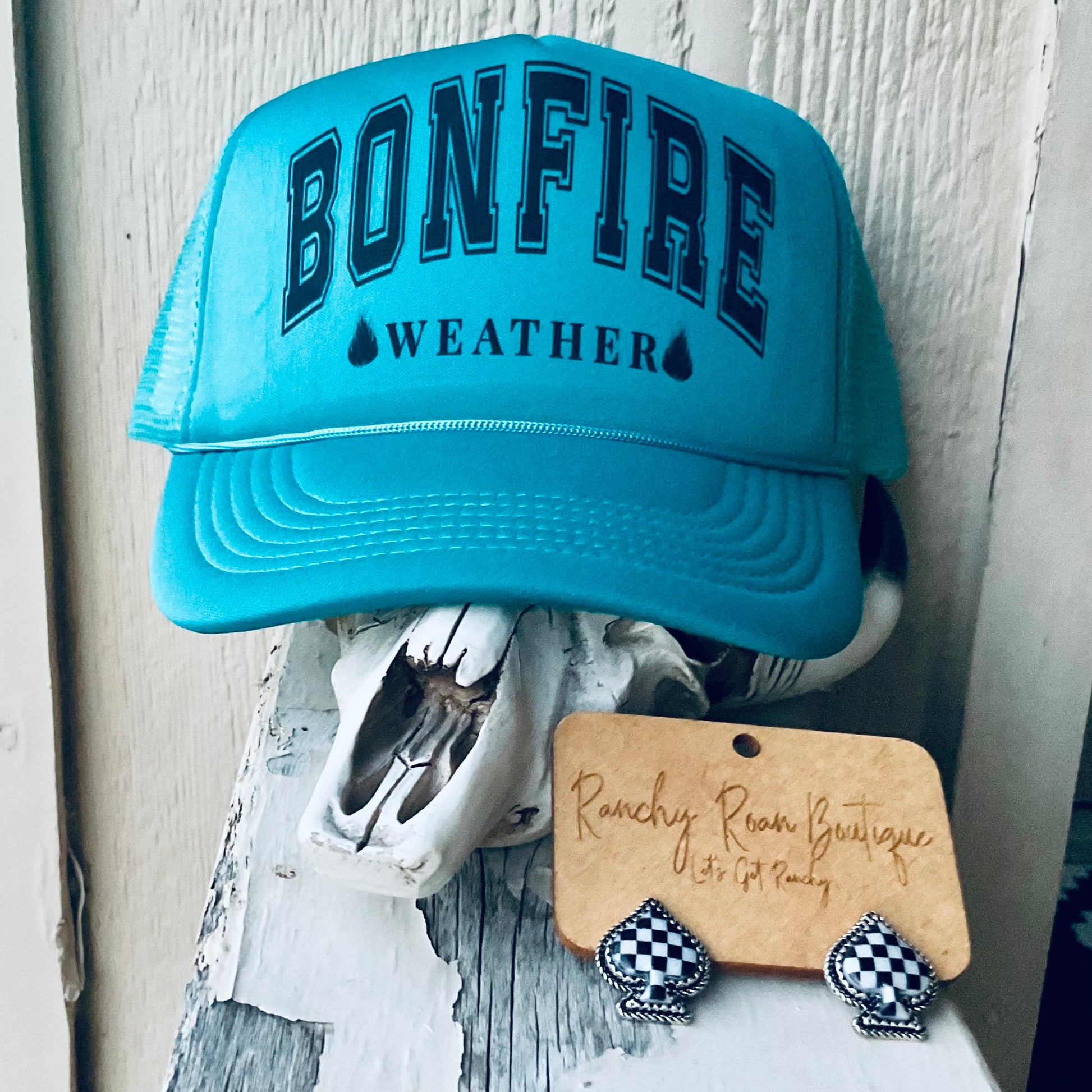 Foam front trucker hat with the bold text “Bonfire Weather” and adjustable snapback closure, featuring breathable mesh and a classic Western style.