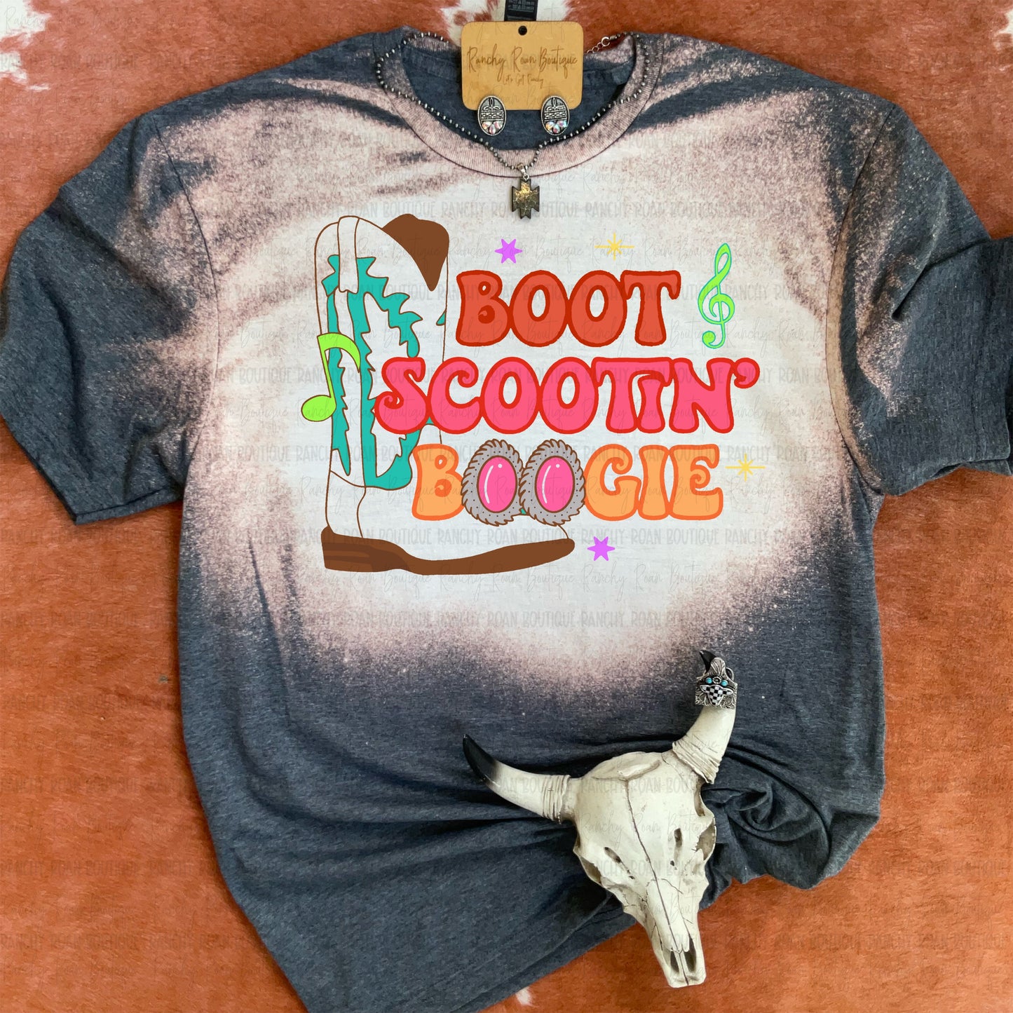Boot Scootin’ Boogie graphic t-shirt with colorful cowboy boot and retro Western design on bleached dark heather fabric.