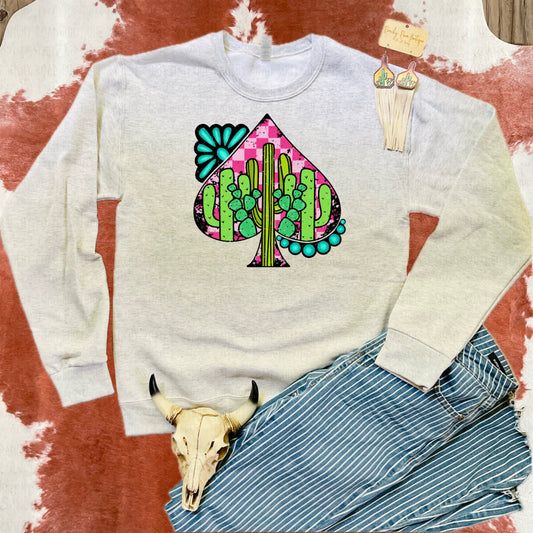 Cactus Turquoise Spade Western Sweatshirt featuring a colorful cactus graphic with turquoise accents framed by a spade shape, styled with rustic Western accessories