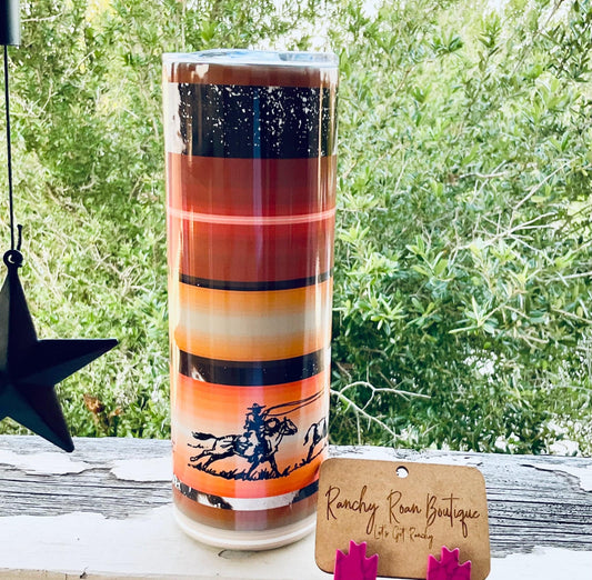 Cowboy Sunset Stripe Western Skinny Tumbler featuring sunset-inspired stripes and a cowboy silhouette, styled with rustic Western accessories.