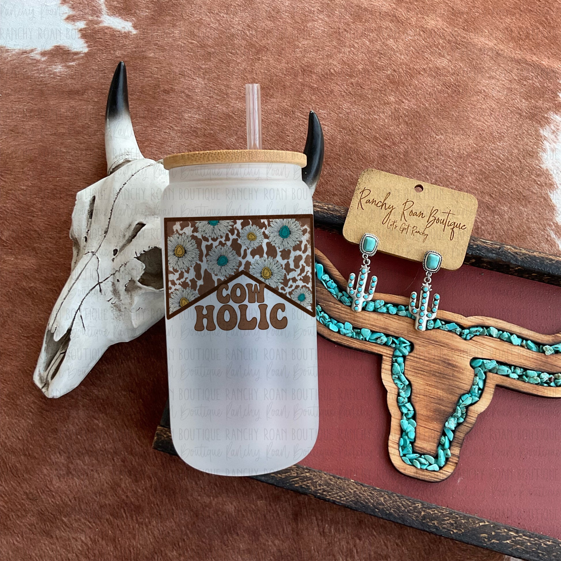 Frosted glass featuring a cow print and floral design with “Cowholic” text, styled with Western-themed accessories.