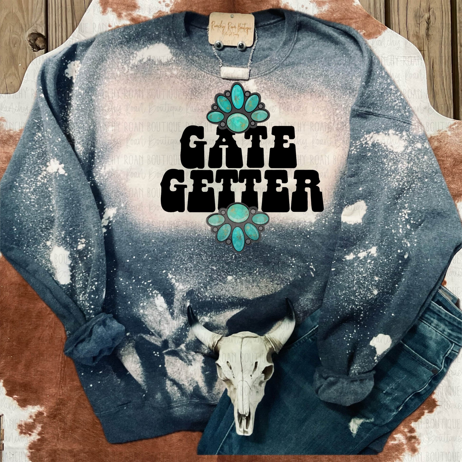 Gate Getter Distressed Western Sweatshirt featuring a turquoise concho graphic with bold text, hand-bleached splatter design on a dark background.