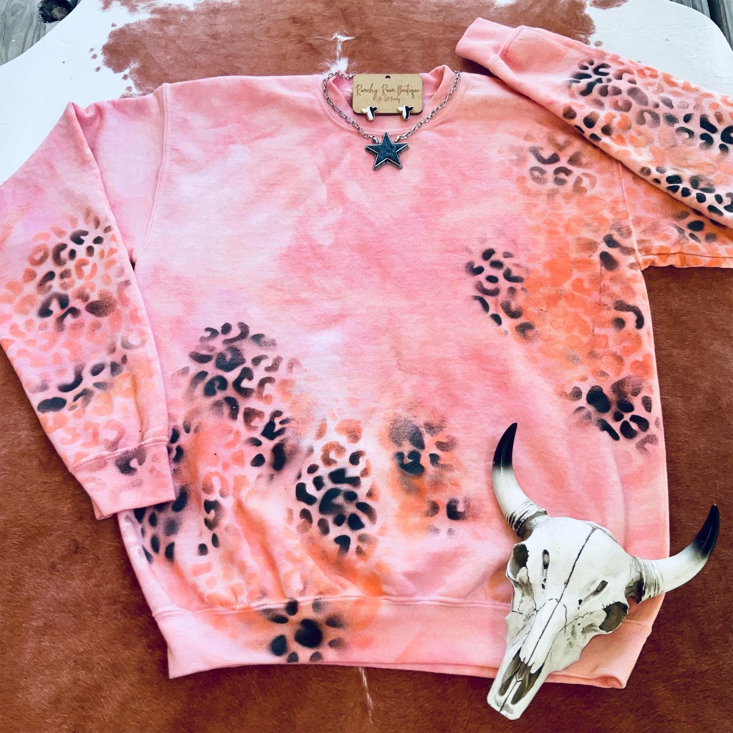 Second view of the Orange Leopard Distressed Western Sweatshirt, showcasing the unique leopard splatter design and vibrant colors.