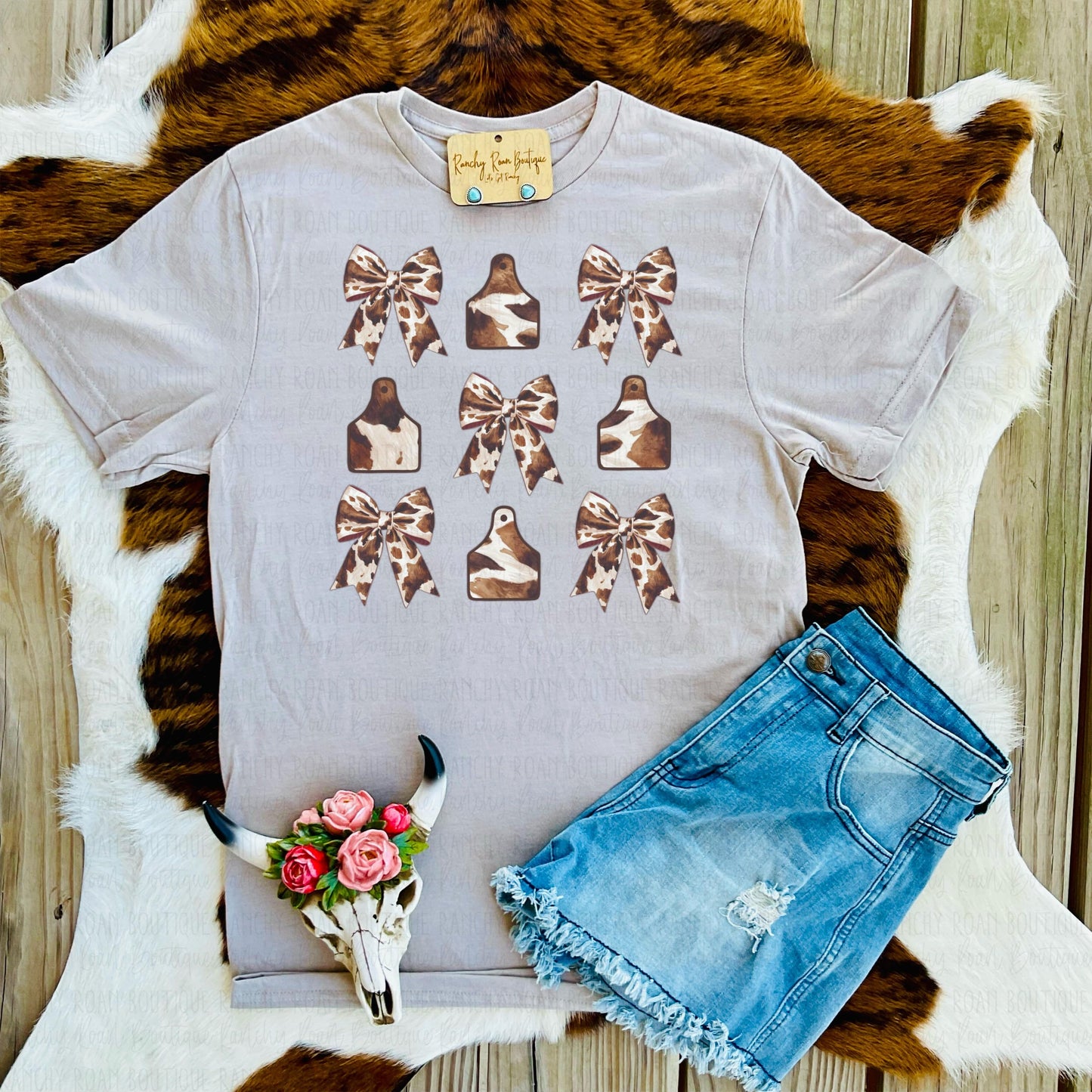 Cow Print Bow and Cow Tag Western Graphic Tee in Sandstone with Brown and Tan Bow & Cow Tag Sublimation Design