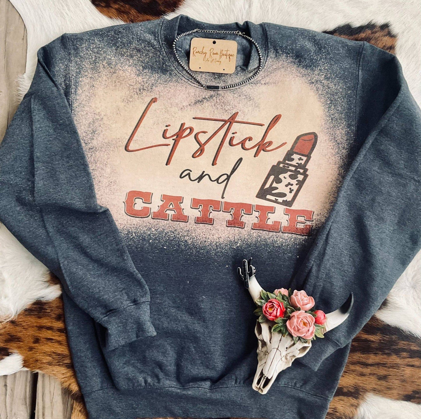 Lipstick and Cattle Western Graphic Sweatshirt In a rustic cow hide backdrop