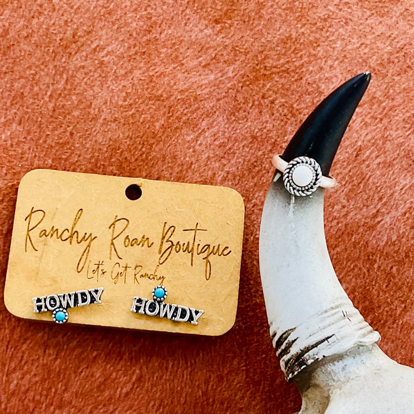 Mini white turquoise adjustable ring paired with Howdy turquoise stud earrings, styled on a rustic horn and card background.
