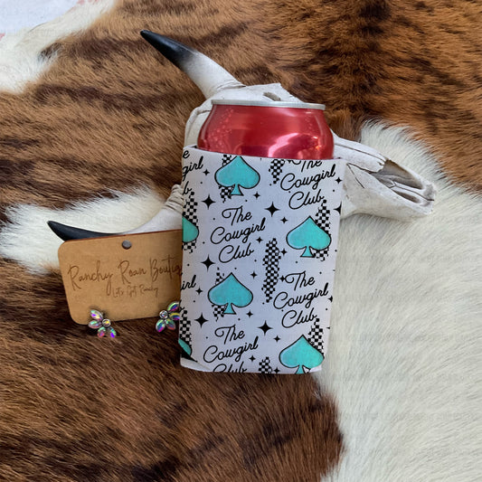 The Cowgirl Club can koozie with turquoise spades and checkerboard Western print on cowhide backdrop