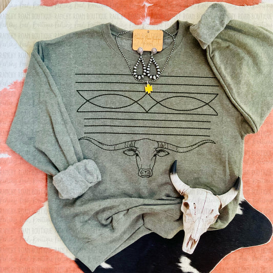 Western Longhorn Boot Stitch Sweatshirt featuring a longhorn and boot stitch design, displayed with Western jewelry and skull decor on a cowhide background.