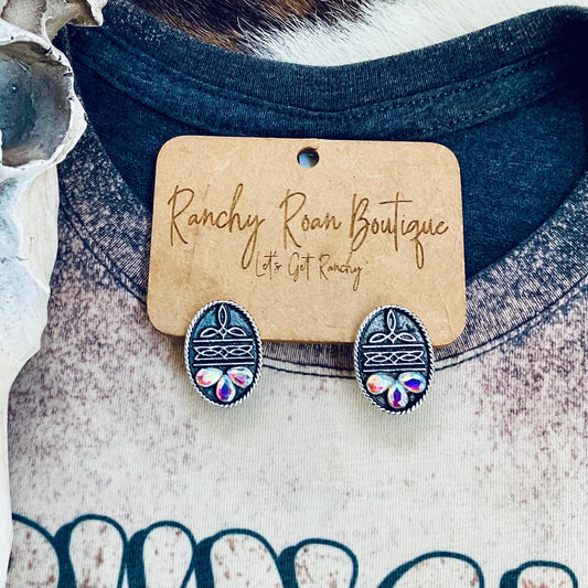  Oval-shaped stud earrings featuring Western boot stitch engravings and iridescent stones, displayed on a Ranchy Roan Boutique card.