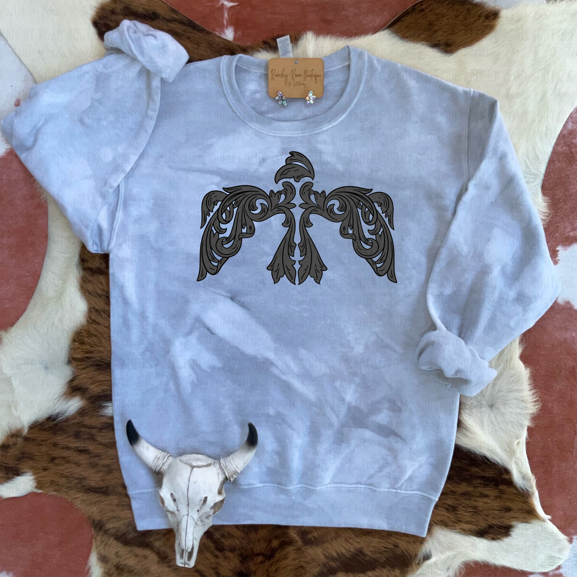 Grey dyed sweatshirt featuring a Western-style tooled thunderbird graphic with intricate detailing.