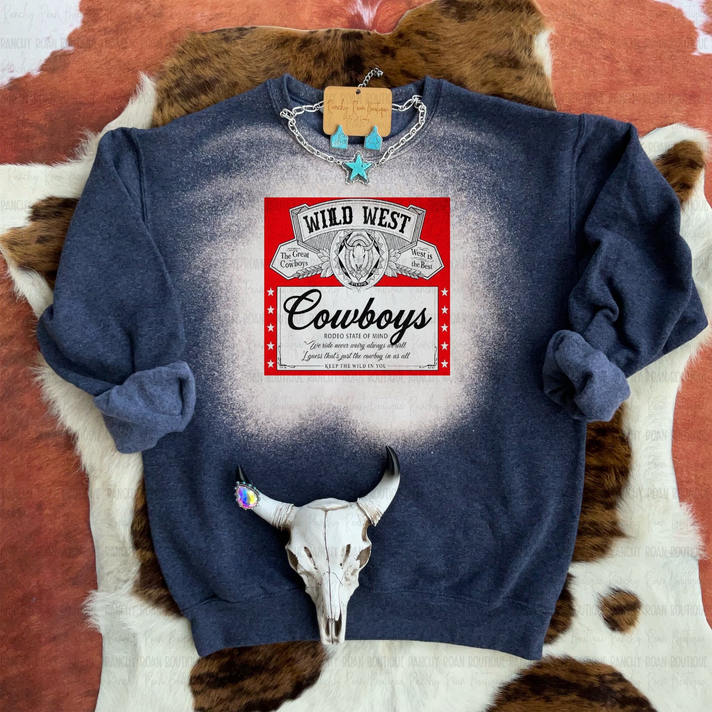 Wild West Cowboys bleached graphic sweatshirt with red vintage label design and Western rodeo style.